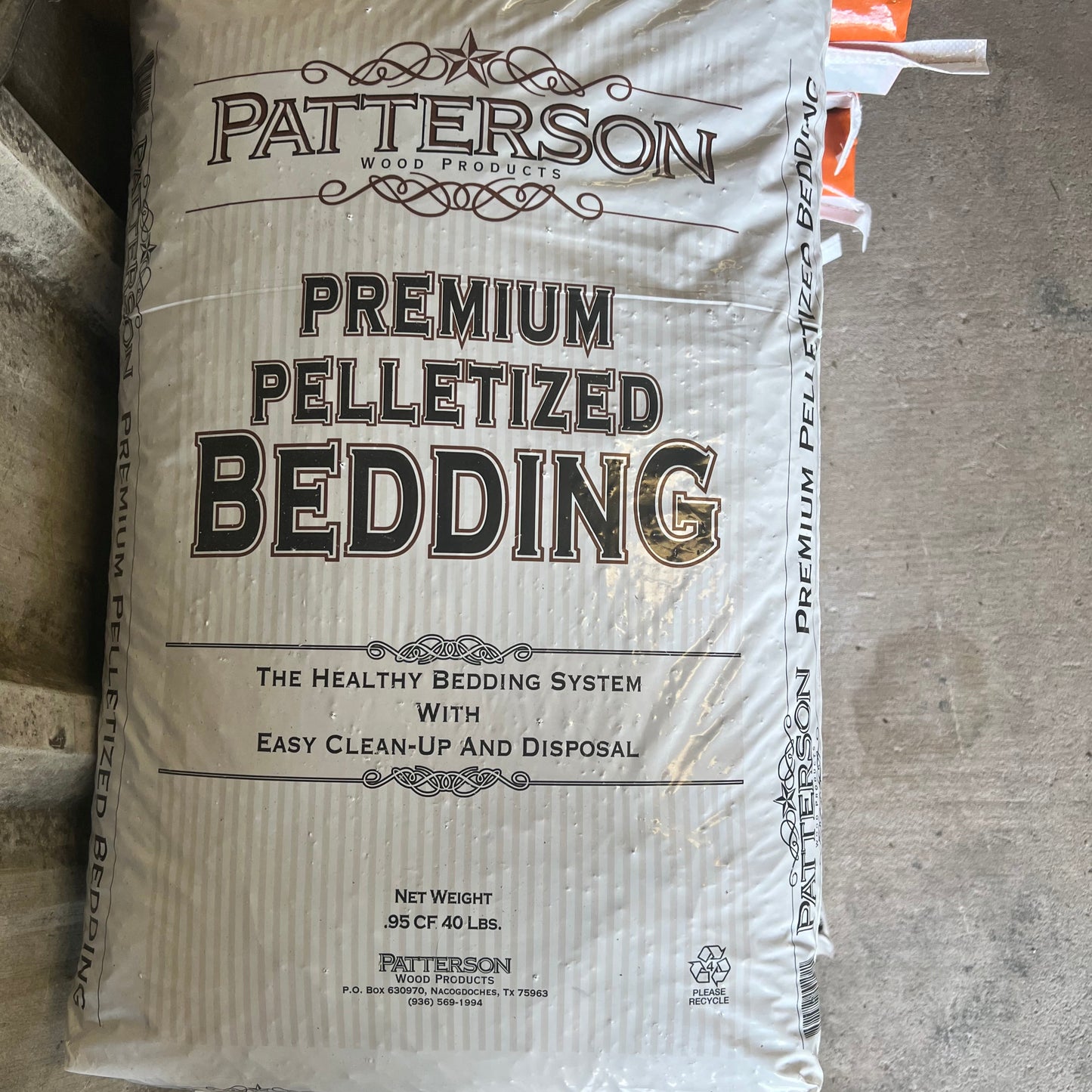 Bag of Patterson Premium Pelletized Bedding on a concrete floor